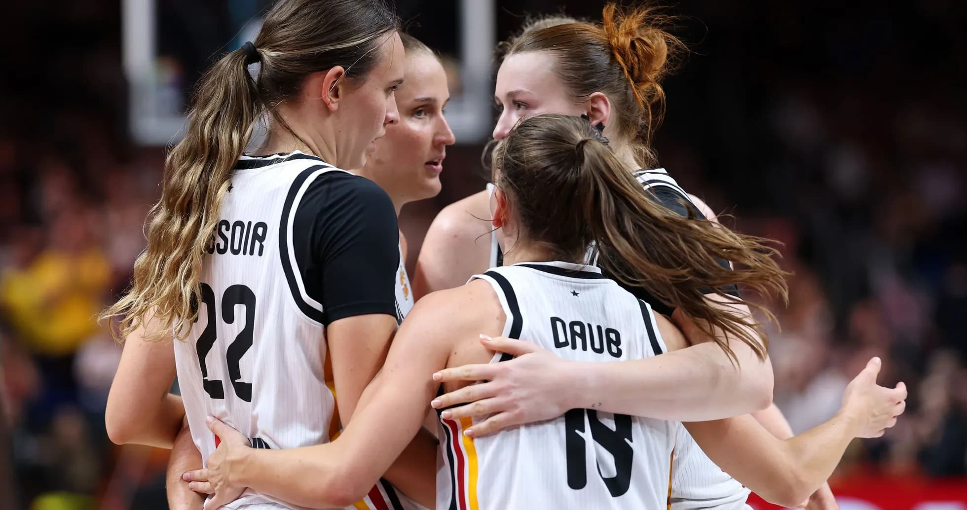 Basketball players celebrating in a huddle Basketball players celebrating in a huddle