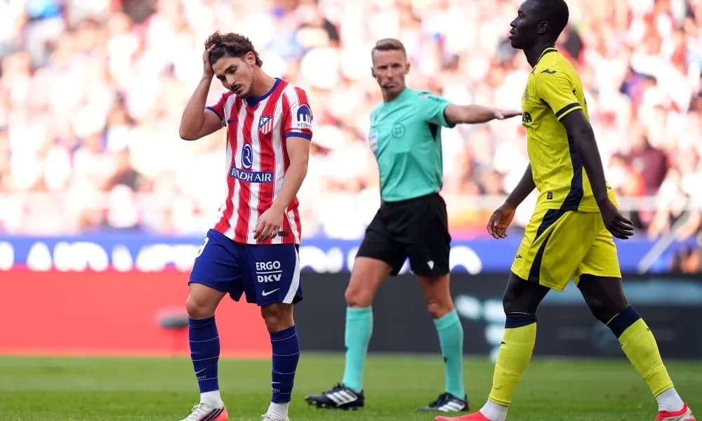 Player holding head with referee signaling during match Player holding head with referee signaling during match