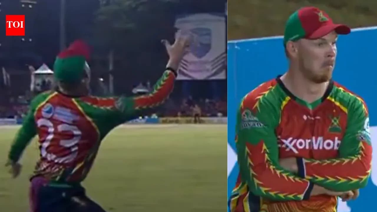 Cricketer catching ball during match play Cricketer catching ball during match play