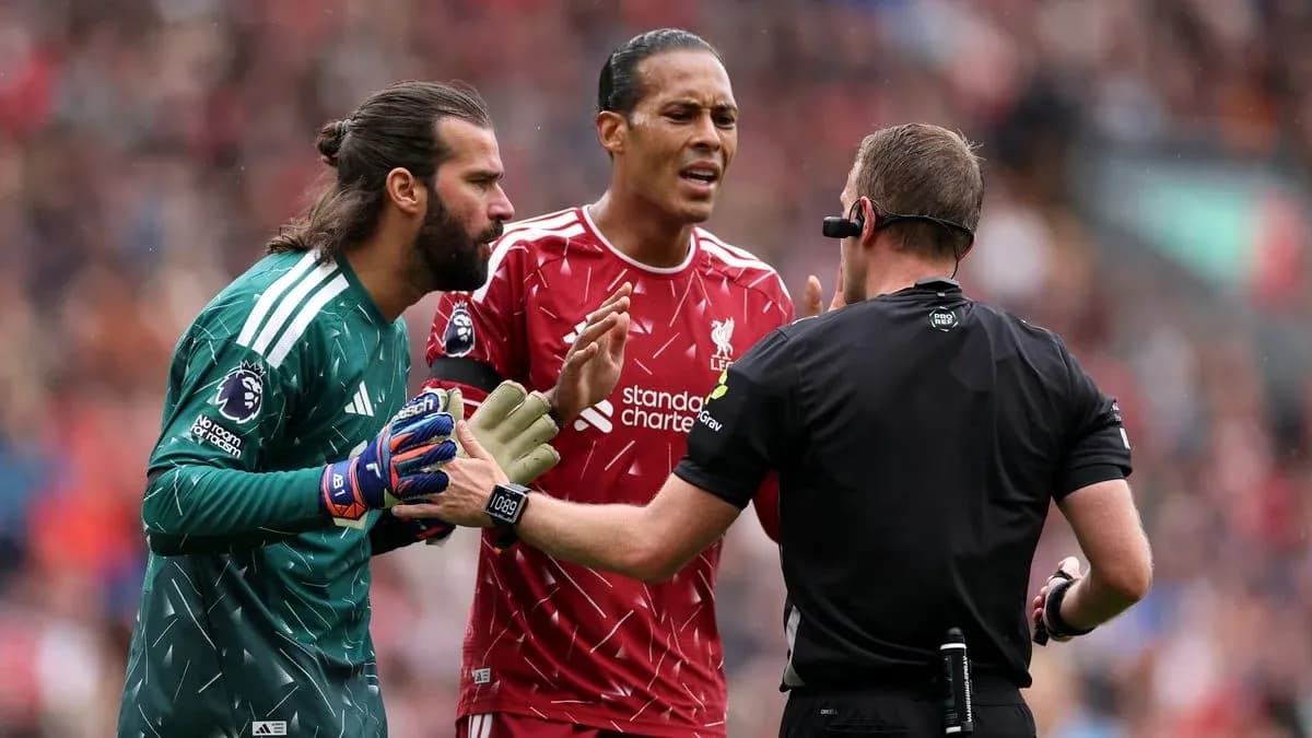 Liverpool players discussing with referee during match Liverpool players discussing with referee during match