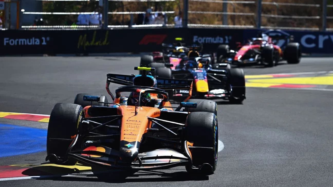 Formula 1 cars racing on a circuit track Formula 1 cars racing on a circuit track
