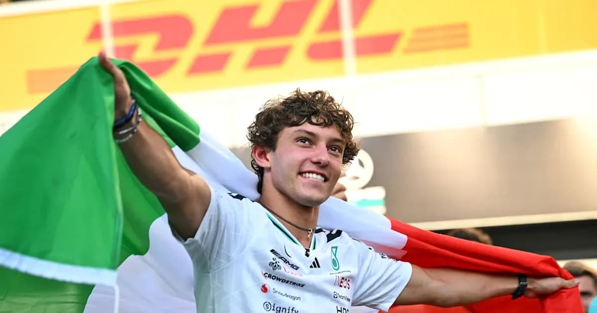 Driver celebrating with Italian flag after race Driver celebrating with Italian flag after race