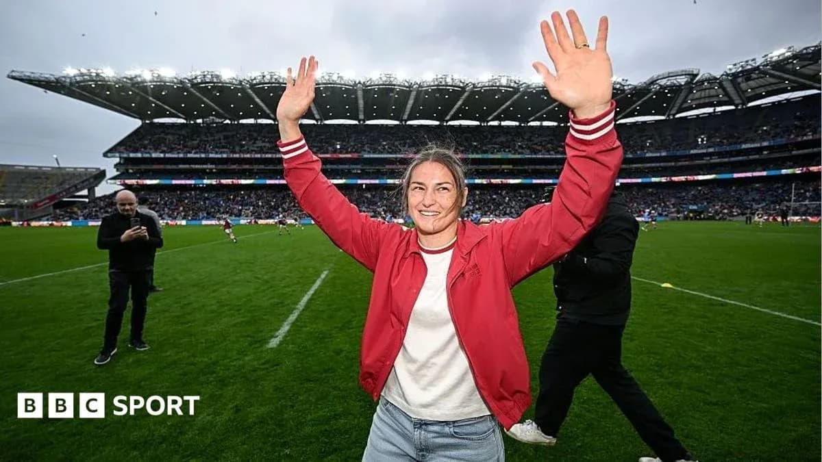 Woman celebrating on the rugby field with raised hands Woman celebrating on the rugby field with raised hands