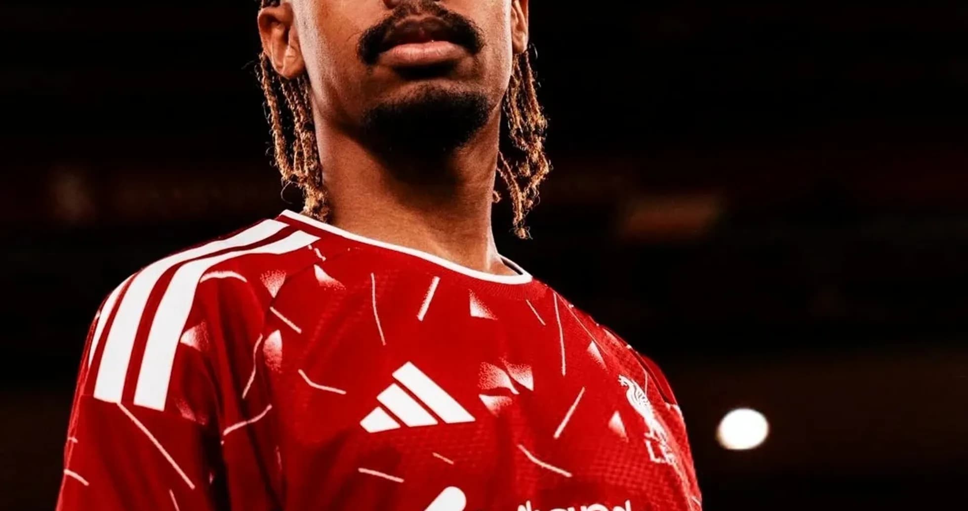 Player wearing red jersey with club logo Player wearing red jersey with club logo