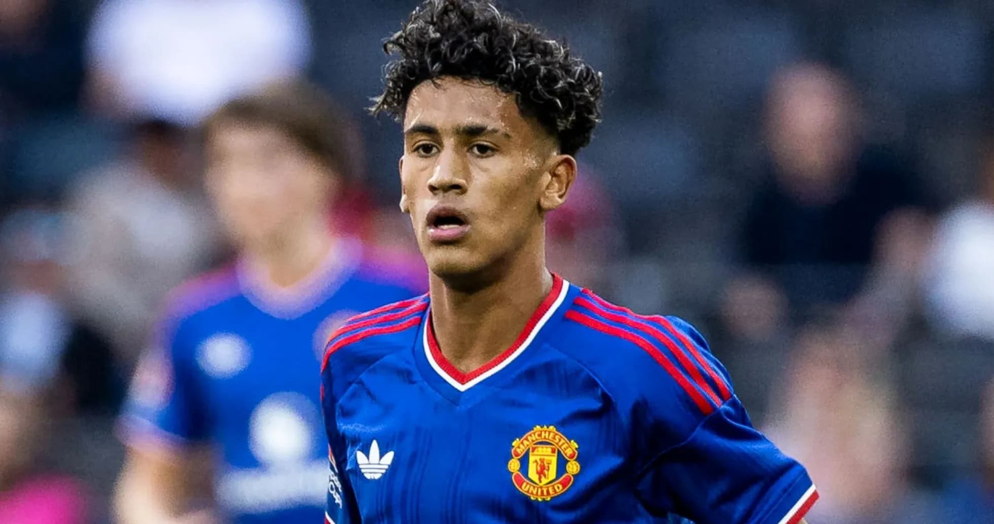 Young player wearing Manchester United jersey on field Young player wearing Manchester United jersey on field