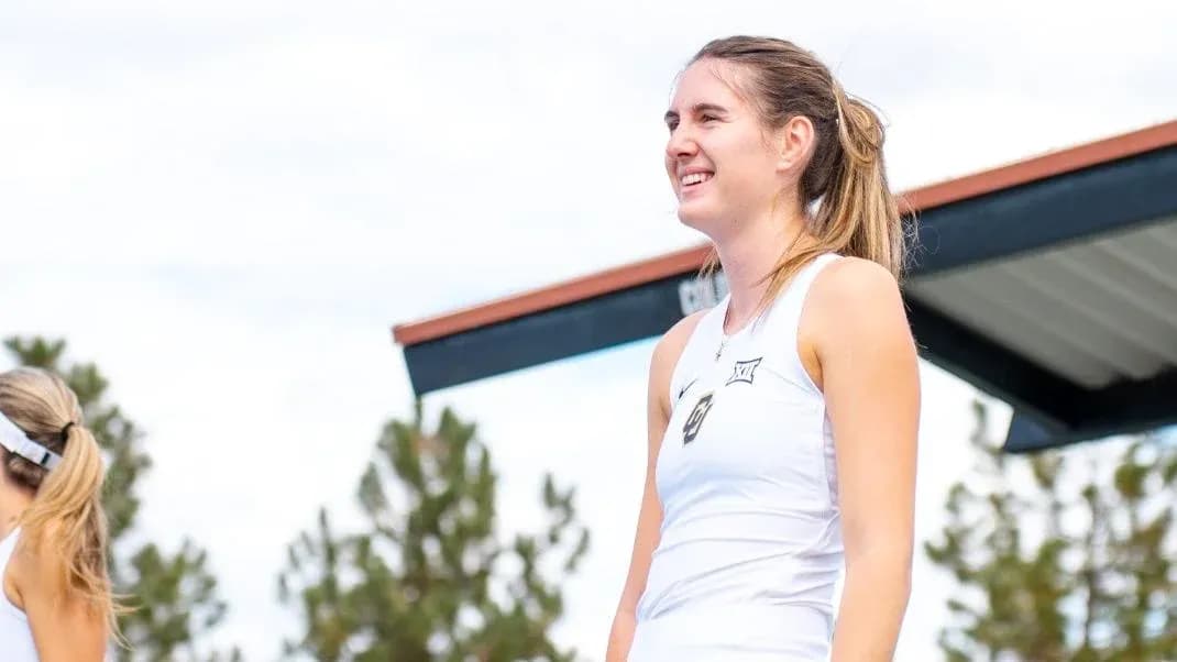 Tennis player smiling on court during event Tennis player smiling on court during event