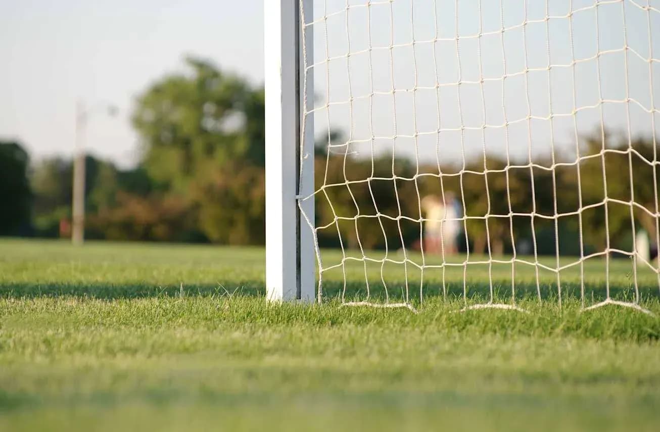 Close-up of soccer goal net on field Close-up of soccer goal net on field