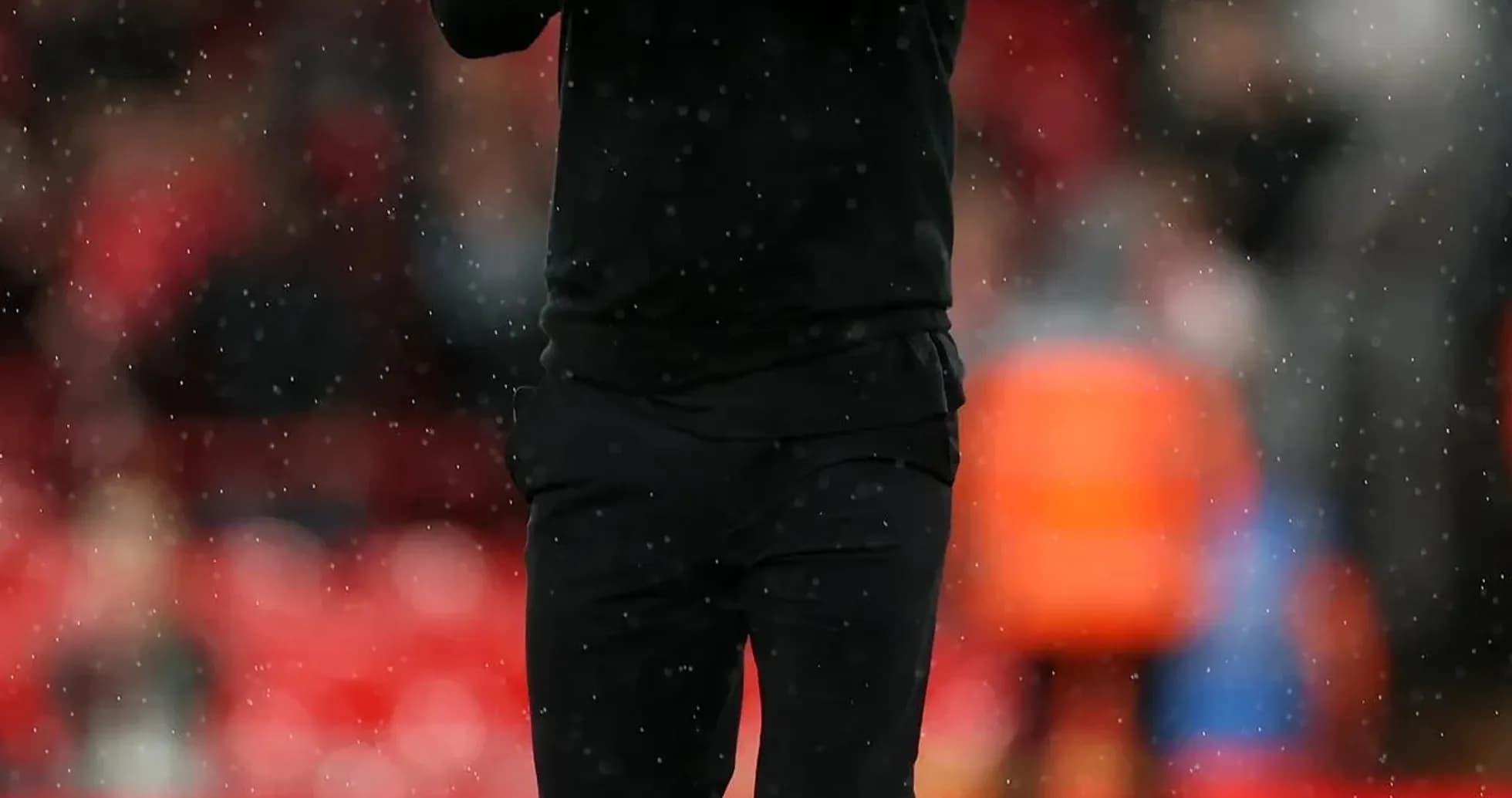 Manager applauding fans during rainy match Manager applauding fans during rainy match