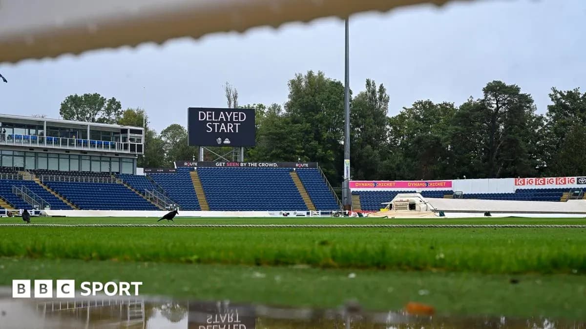Cricket ground with delayed start sign and wet pitch Cricket ground with delayed start sign and wet pitch