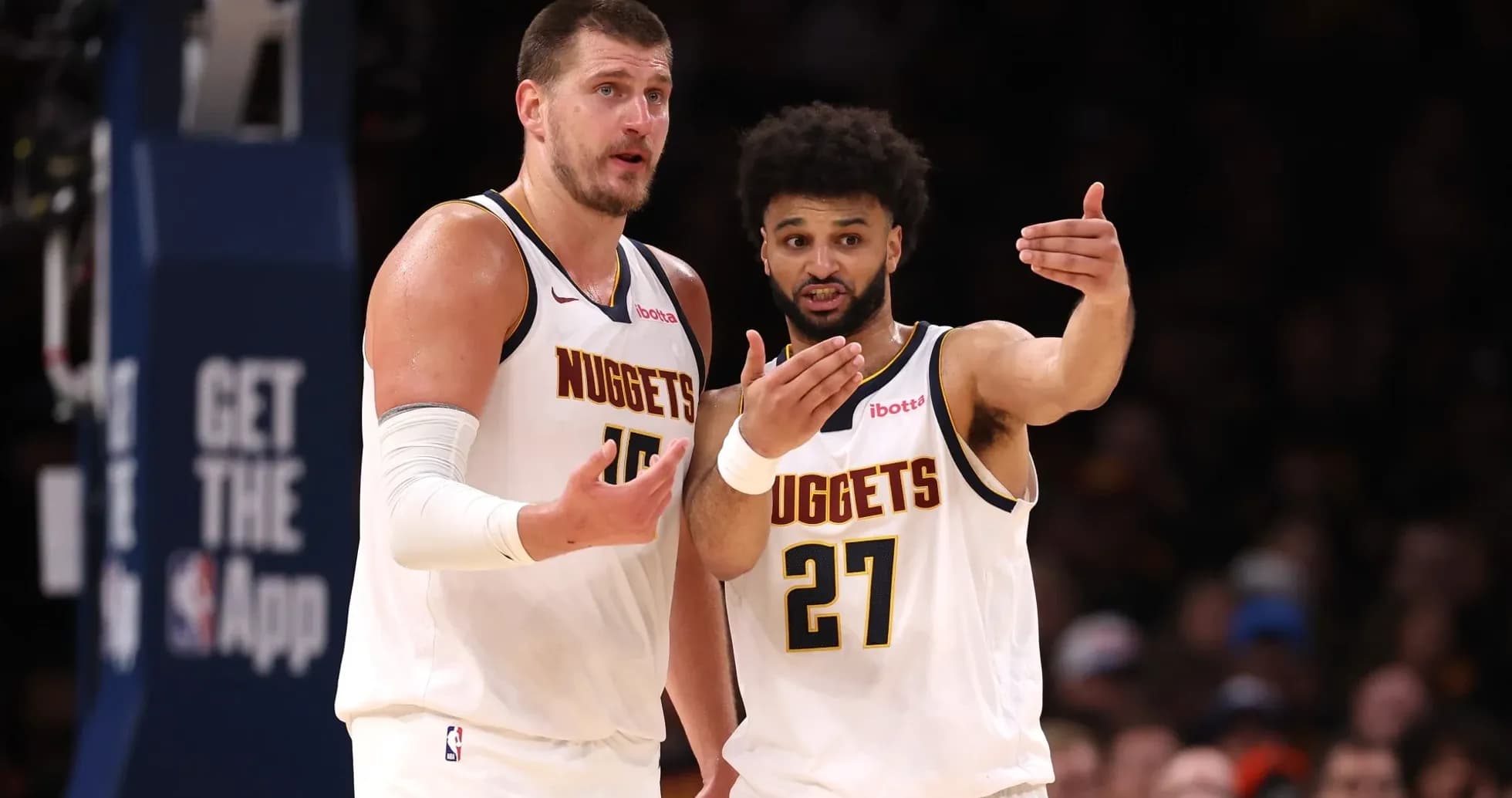 Two Denver Nuggets players discussing during game Two Denver Nuggets players discussing during game