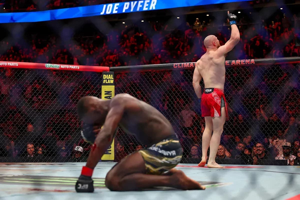 Joe Pyfer celebrating victory over opponent in octagon Joe Pyfer celebrating victory over opponent in octagon
