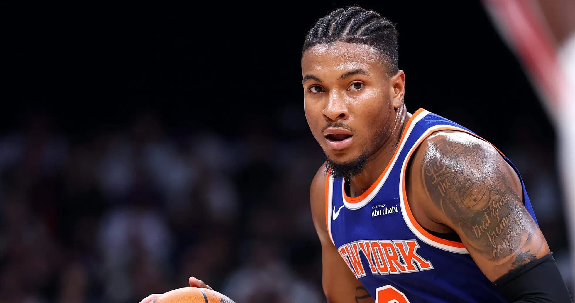 Player dribbling basketball during a game Player dribbling basketball during a game