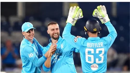 England players celebrating a wicket on the field England players celebrating a wicket on the field