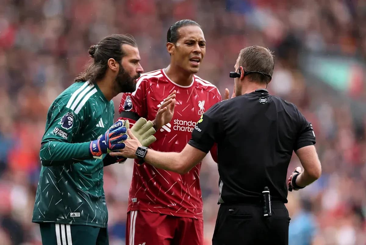 Liverpool players arguing with referee during match Liverpool players arguing with referee during match