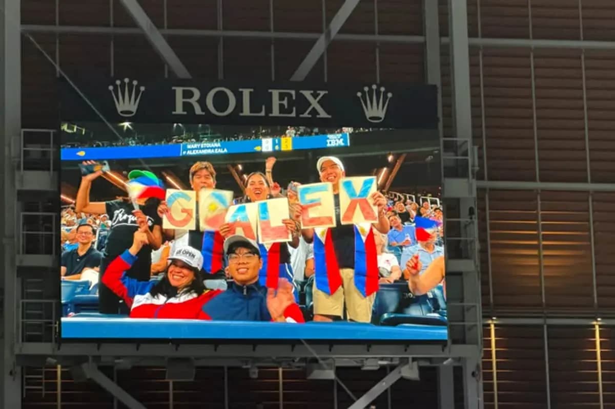 Fans holding a sign that says 'GO ALEX' in stadium Fans holding a sign that says 'GO ALEX' in stadium