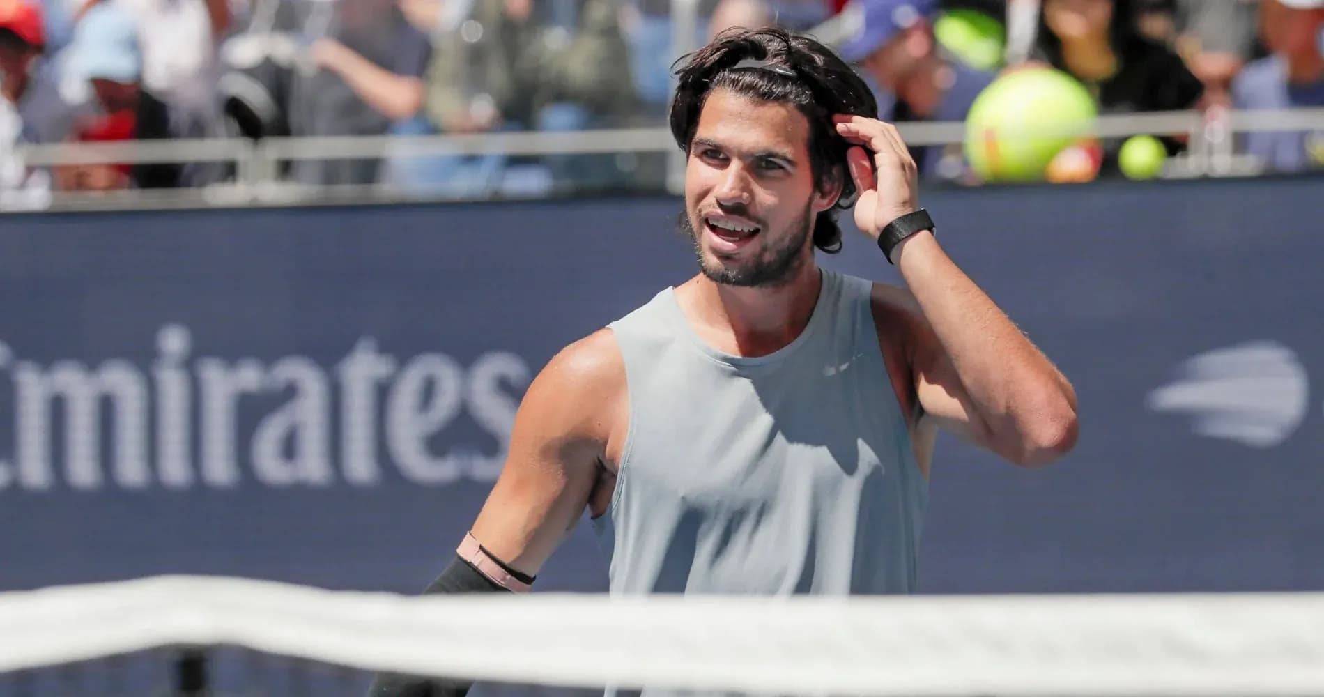 Tennis player adjusting hair during a match Tennis player adjusting hair during a match
