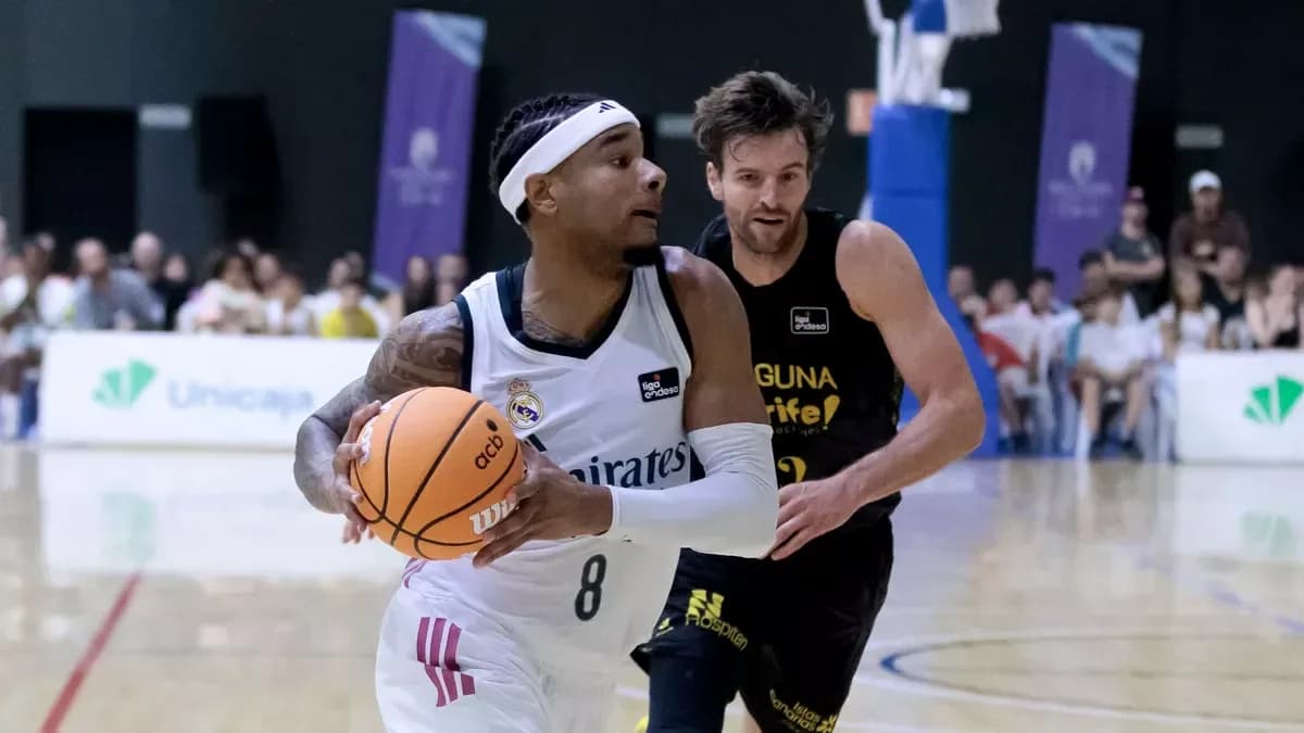Player dribbling basketball while being chased by opponent Player dribbling basketball while being chased by opponent