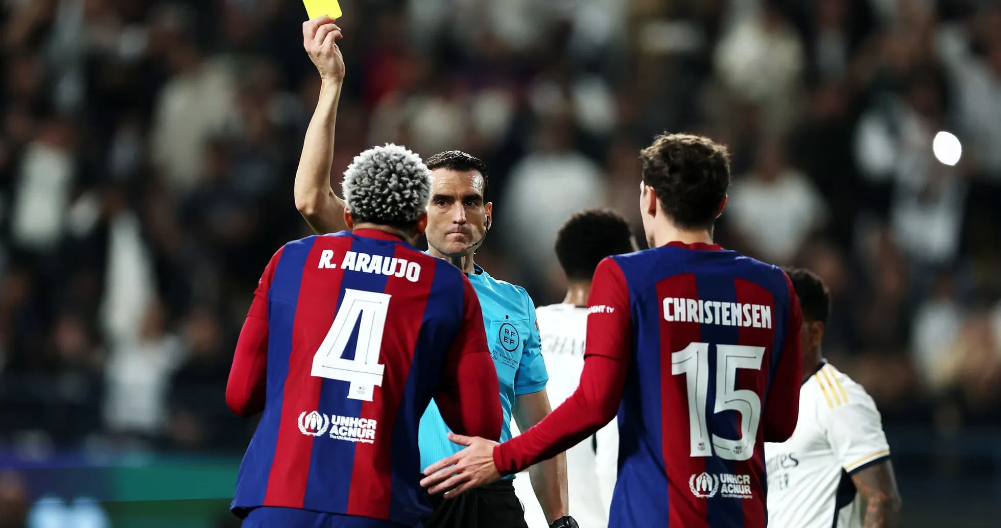 Referee showing yellow card to player during match Referee showing yellow card to player during match