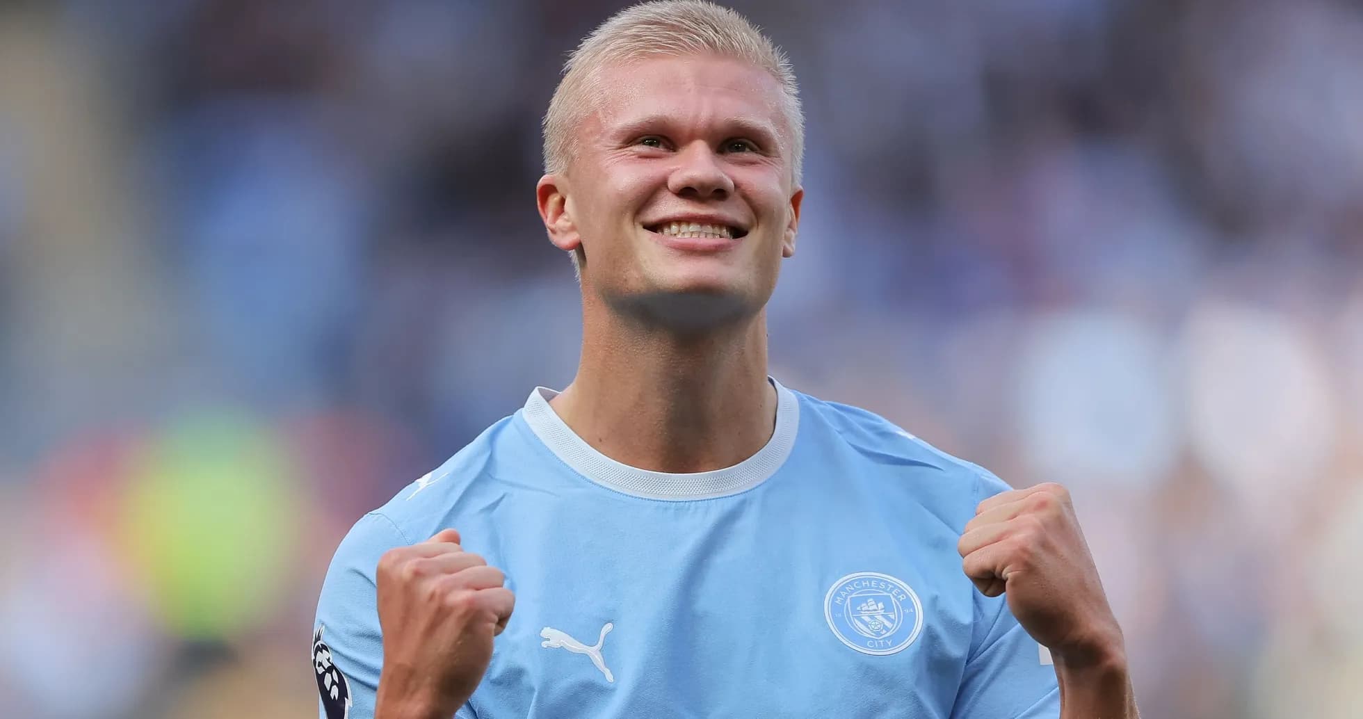 Player celebrating in Manchester City kit on field Player celebrating in Manchester City kit on field