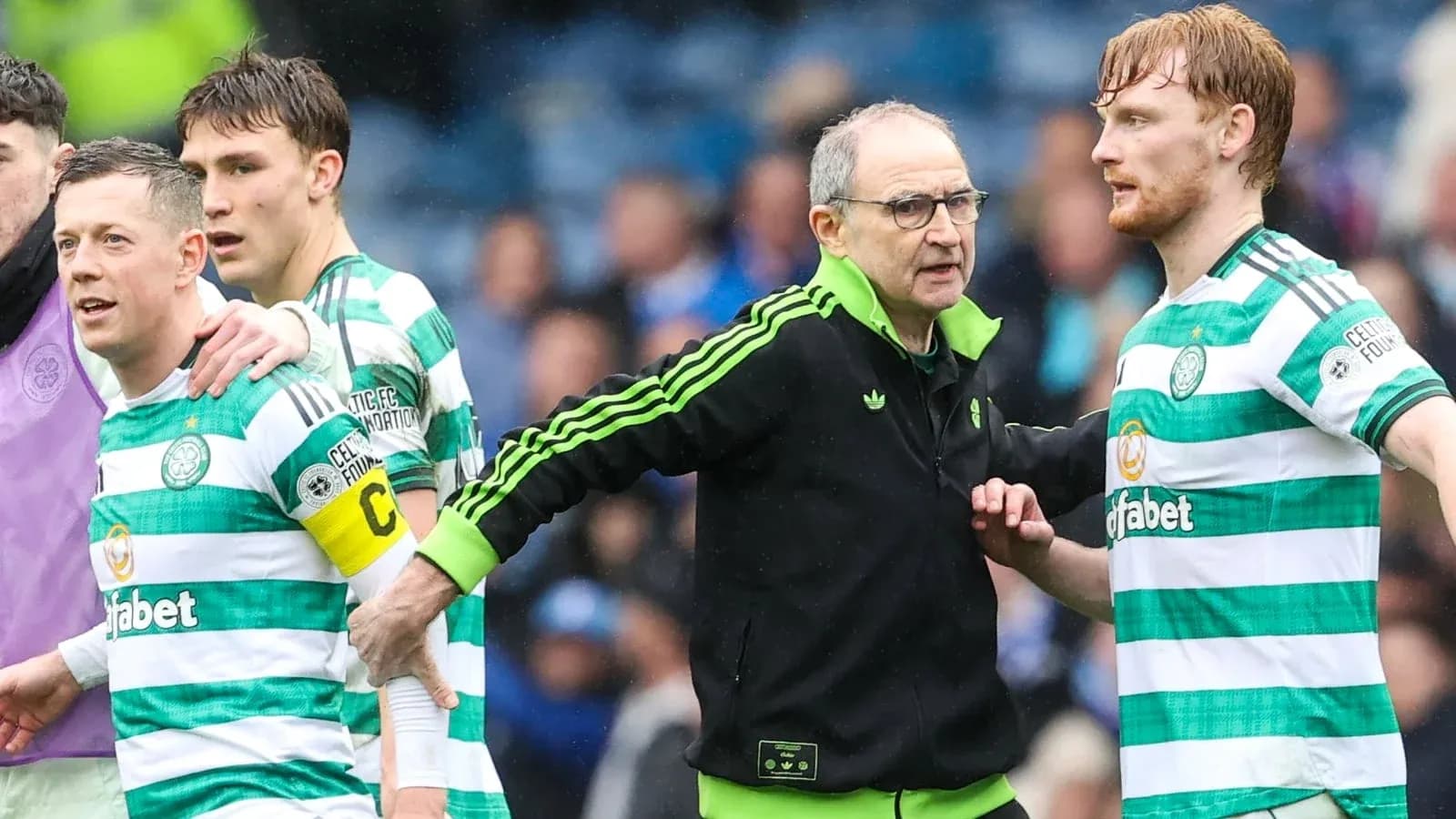 Celtic players and manager interacting on the pitch Celtic players and manager interacting on the pitch