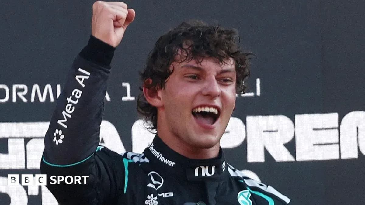 Racing driver celebrating victory with raised fist Racing driver celebrating victory with raised fist