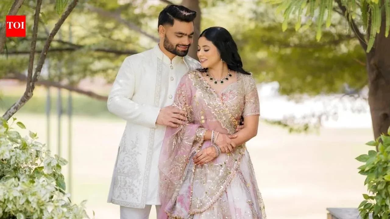 Couple in traditional attire posing outdoors Couple in traditional attire posing outdoors