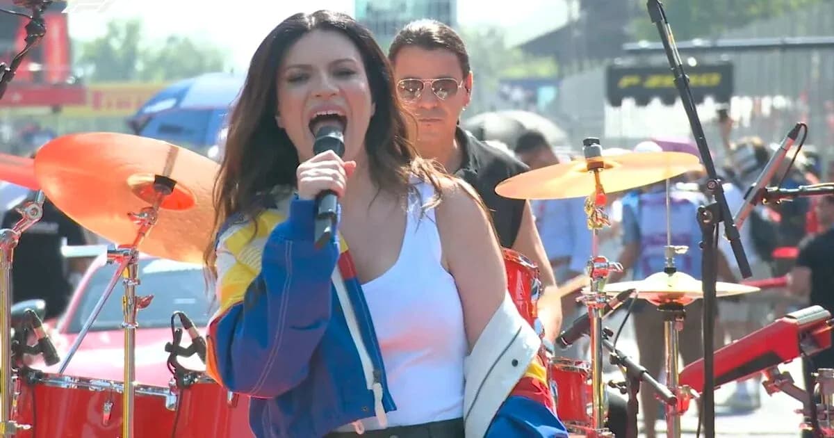 Singer performing on stage with band at event Singer performing on stage with band at event