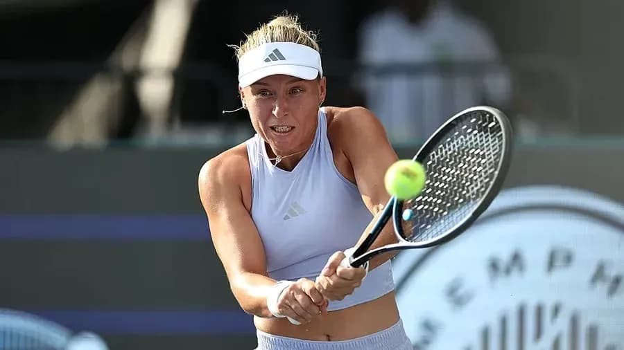Female tennis player hitting a forehand shot Female tennis player hitting a forehand shot