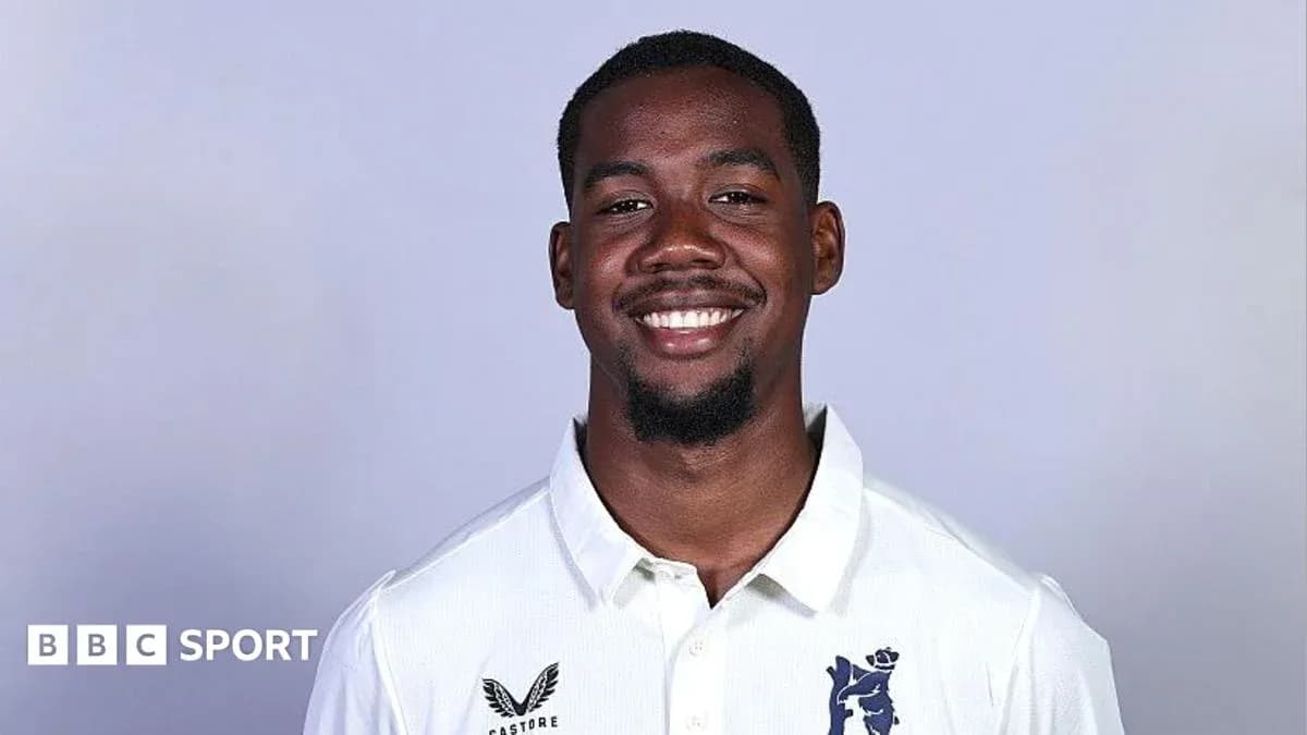 Smiling cricketer in white team shirt portrait Smiling cricketer in white team shirt portrait