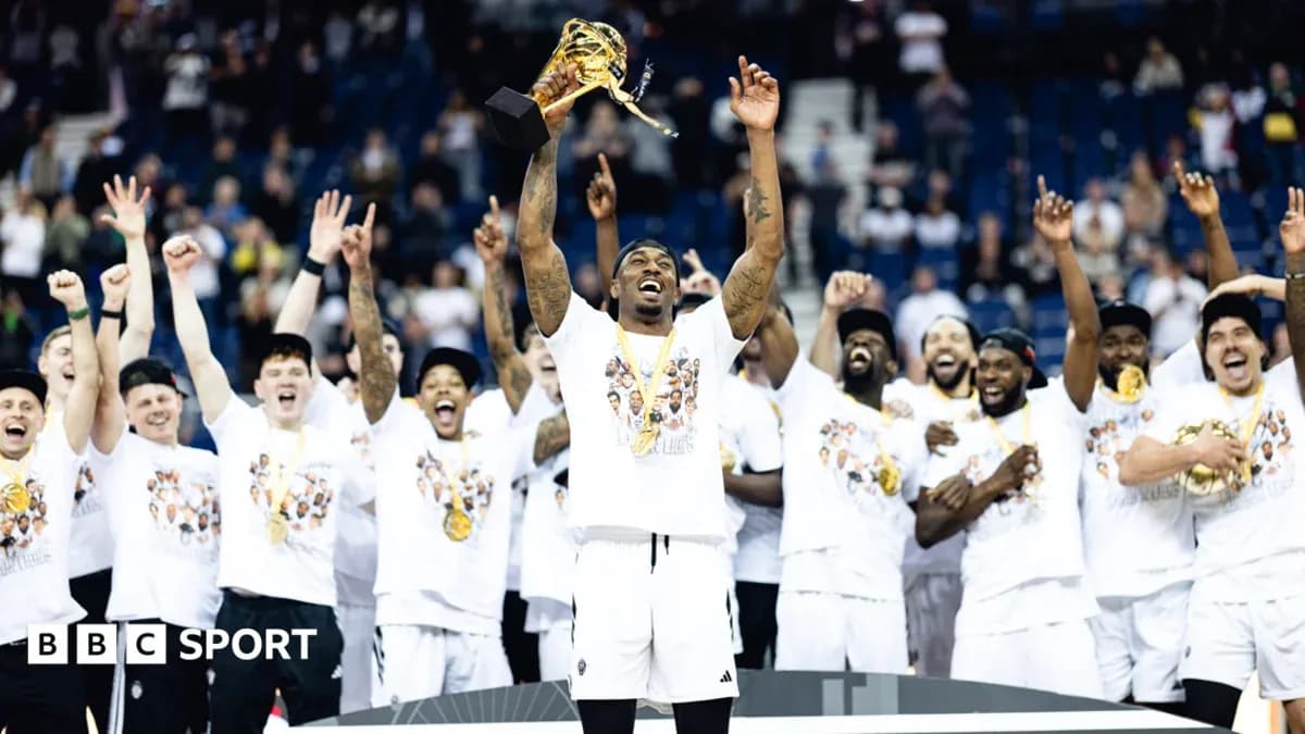 Player celebrating with trophy and teammates after victory Player celebrating with trophy and teammates after victory