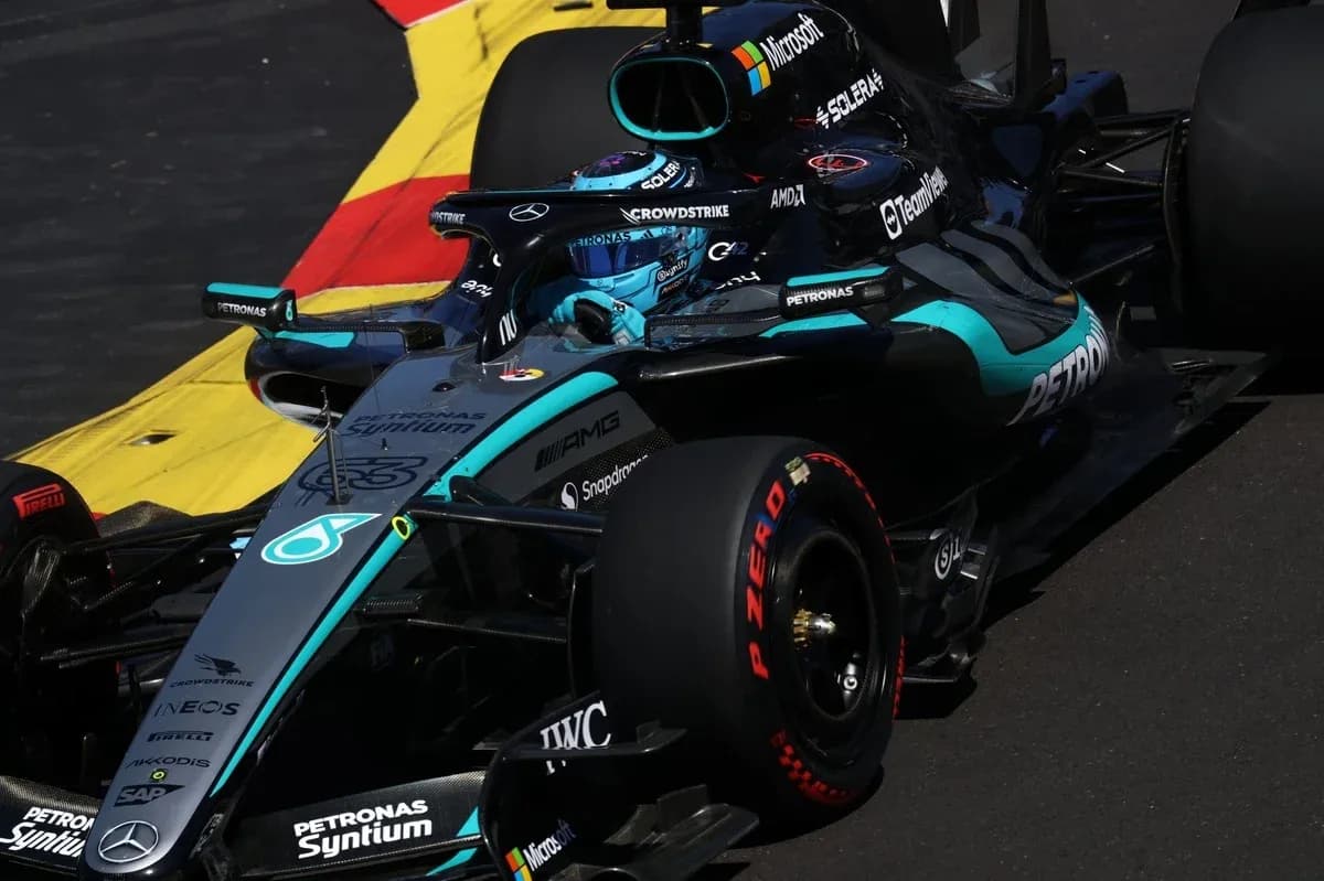 Mercedes F1 car navigating a racetrack corner Mercedes F1 car navigating a racetrack corner