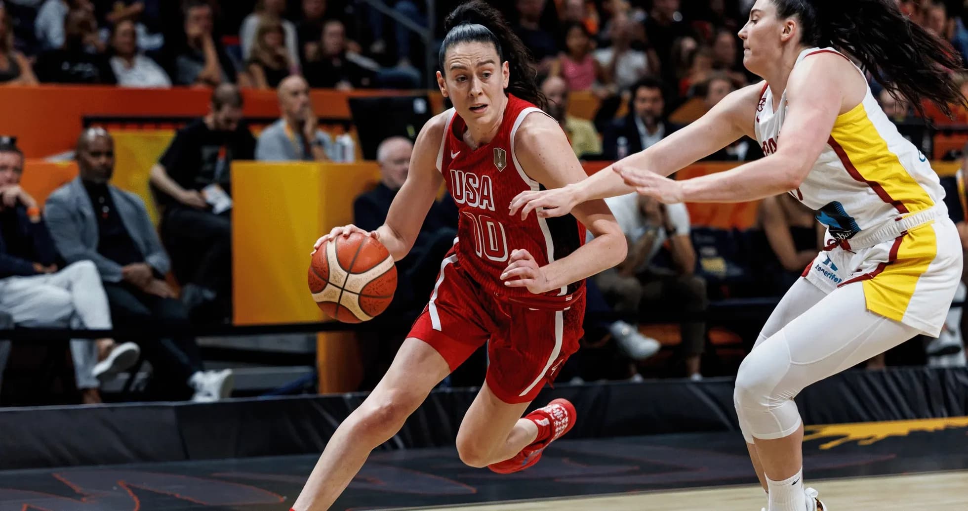 USA player dribbling past defender during game USA player dribbling past defender during game