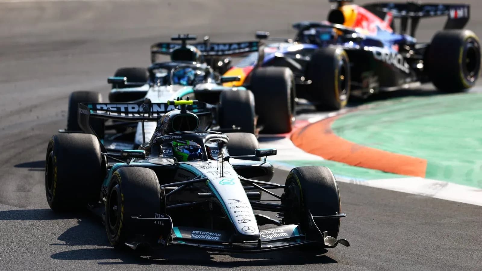 Two Formula 1 cars racing on a track Two Formula 1 cars racing on a track