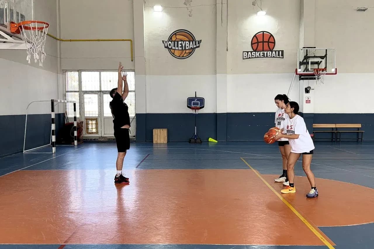 Coach instructing players during basketball practice Coach instructing players during basketball practice