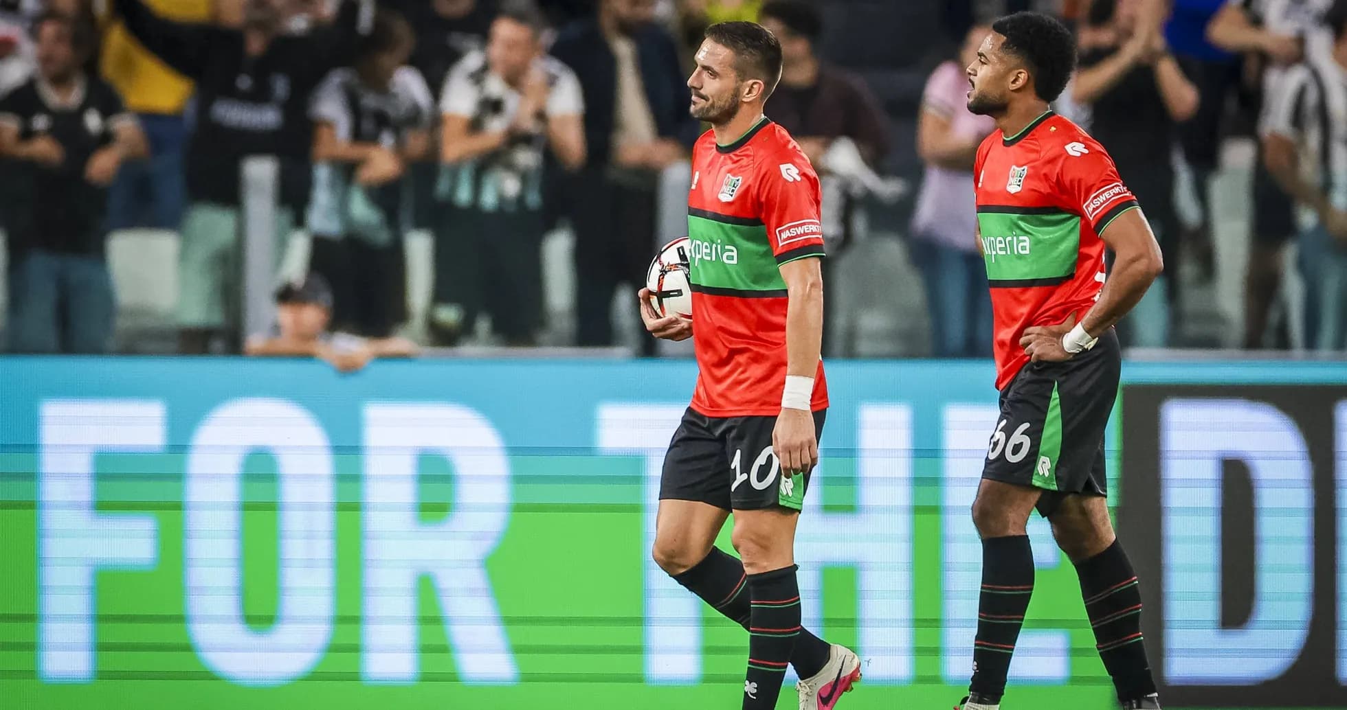 Two players walking off the field after a match Two players walking off the field after a match