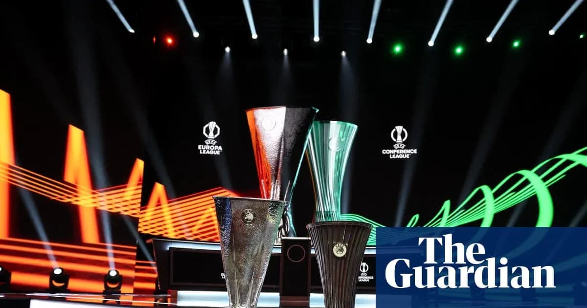 Three UEFA trophies displayed on stage with lighting Three UEFA trophies displayed on stage with lighting