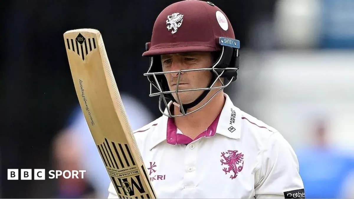 Cricketer holding bat, wearing helmet and uniform Cricketer holding bat, wearing helmet and uniform