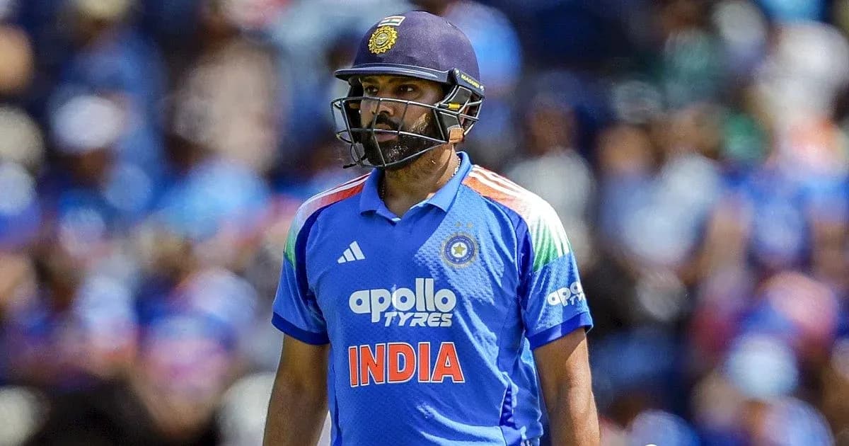 Cricketer in blue uniform walking on the field Cricketer in blue uniform walking on the field