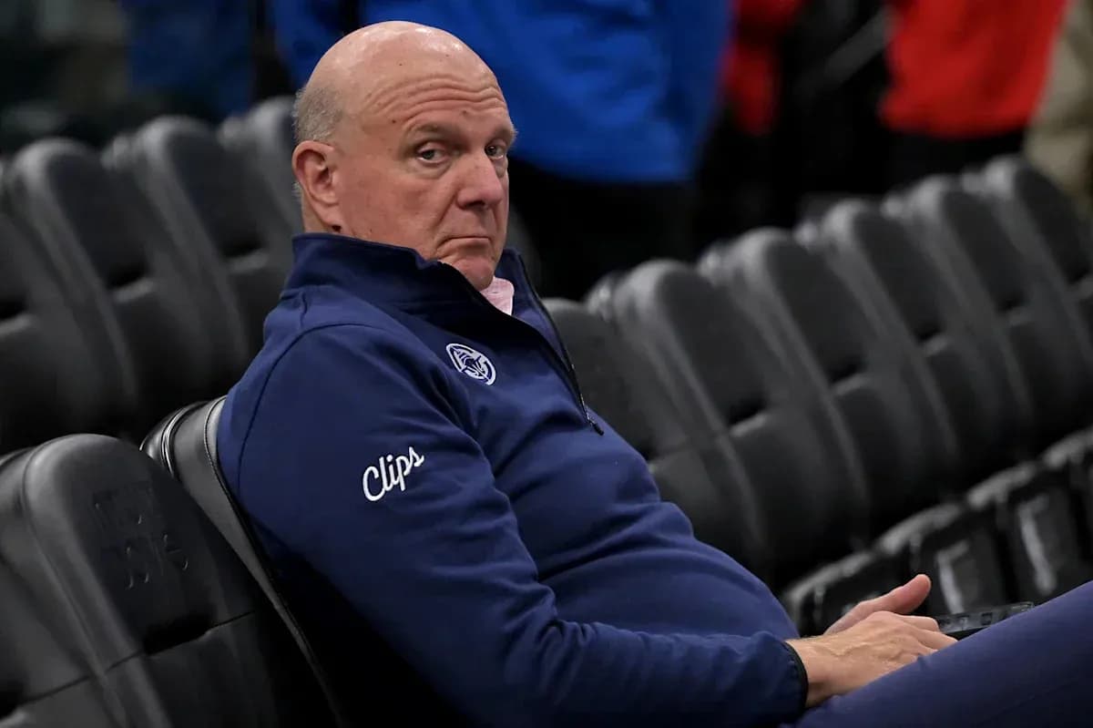Man in Clippers attire sitting in empty arena Man in Clippers attire sitting in empty arena