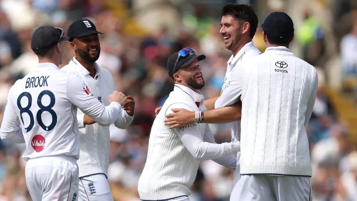 England cricket players celebrating a wicket together England cricket players celebrating a wicket together