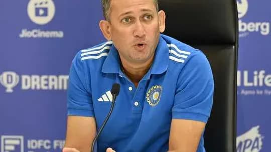 Coach speaking at press conference table Coach speaking at press conference table