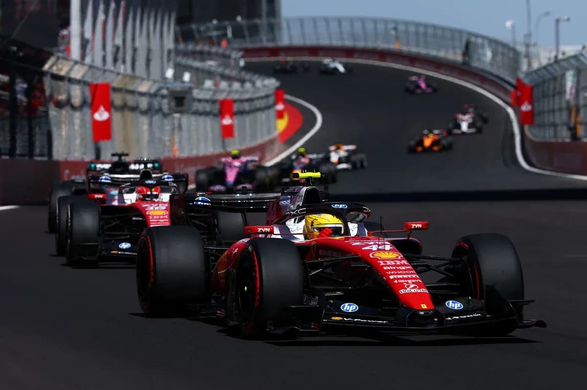 Ferrari car leading other cars on racetrack Ferrari car leading other cars on racetrack