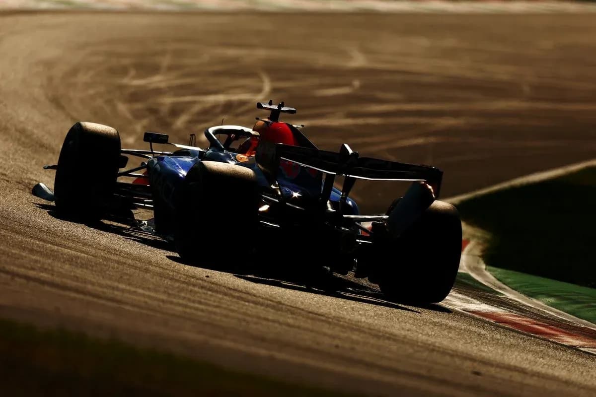Formula 1 car racing on track during sunset Formula 1 car racing on track during sunset