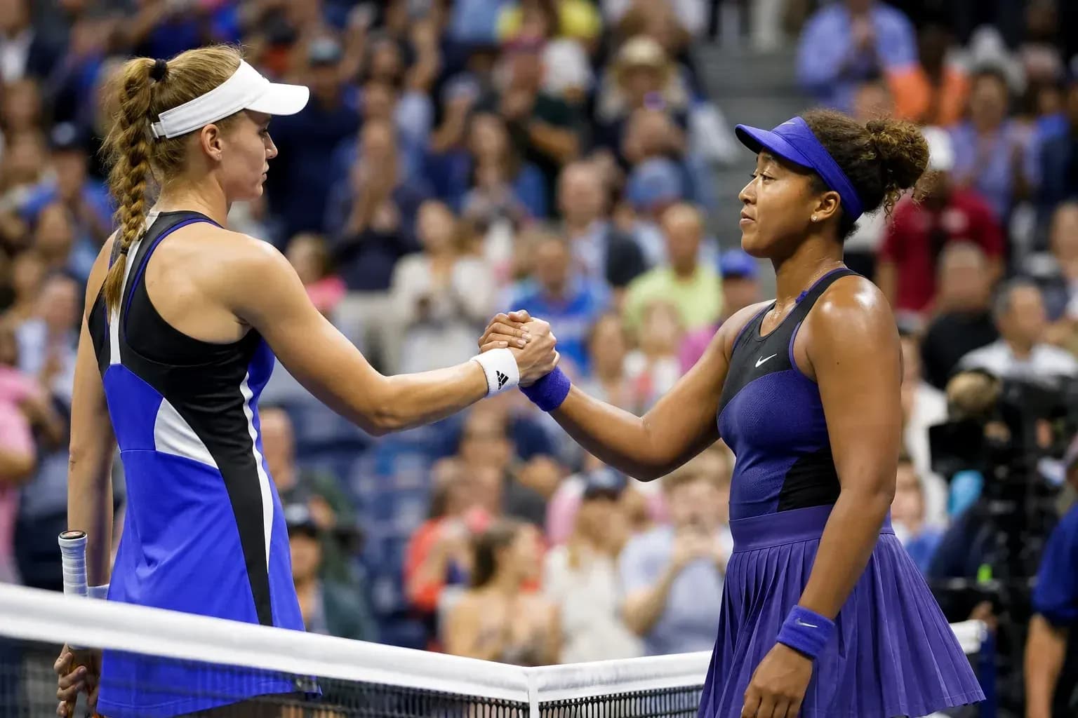Players shaking hands at the net after match Players shaking hands at the net after match